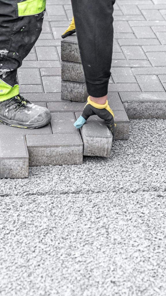 Site preparation and sub-base compaction for large-scale paving project.